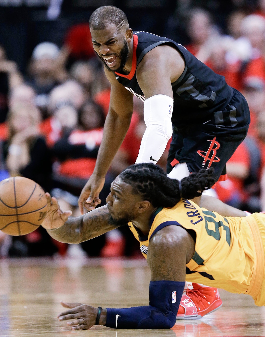Utah Jazz forward Jae Crowder, bottom, and Houston Rockets guard Chris Paul chase the ball during the second half in Game 1 of an NBA basketball second-round playoff series, Sunday, April 29, 2018, in Houston. Houston won 110-96. (AP Photo/Eric Christian Smith)