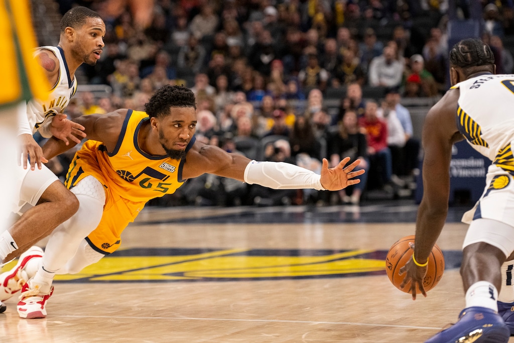 Utah Jazz guard Donovan Mitchell (45) dives for the ball after losing control of it during the second half of an NBA basketball game against the Indiana Pacers in Indianapolis, Saturday, Jan. 8, 2022. (AP Photo/Doug McSchooler)