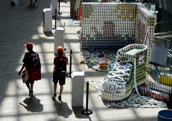 (Scott Sommerdorf | The Salt Lake Tribune) Visitors to the Salt Lake City Public Library walk past the stepexpress.com shoe made out of cans and sardines for he laces as the library hosted a community display and food drive focused on healthy food items for the Utah Food Bank. Teams from six local health careÐrelated businesses built giant sculptures using healthy canned, bagged, and boxed foods. The replica of Rice-Eccles Stadium won the public choice award, Thursday, August 10, 2017.