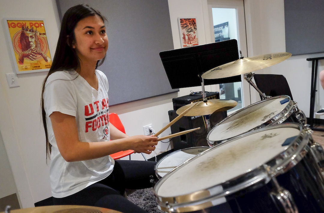 (Francisco Kjolseth  |  The Salt Lake Tribune)  Cassidy Azarcom, 15, takes a turn on the drums as she jams with other students in the after school music program  MusicGarage.org, in Sugarhouse on Monday, May 20, 2019.