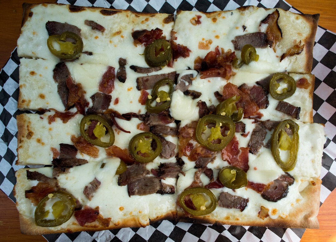 (Rick Egan  |  The Salt Lake Tribune) The Pancho Villa pizza, with white sauce mozzarella, beef brisket, bacon and, jalapenos is a favorite from the Umani food truck.