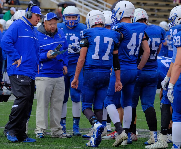 (Leah Hogsten  |  The Salt Lake Tribune) Coaches check on Beaver's quarterback Porter Hollingshead who limps over to them.  Beaver High School boys' football team defeated Delta High School 35-16 during their class 2A state semifinal football game Saturday, November 4, 2017 at Weber State University's Stewart Stadium.