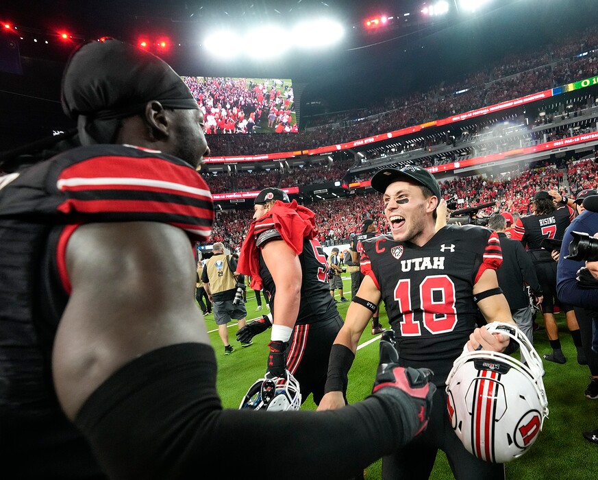 (Leah Hogsten | The Salt Lake Tribune) Utah Utes linebacker Devin Lloyd (0) and Utah Utes wide receiver Britain Covey (18) celebrate the win. The Utes defeated the Oregon Ducks to win the 2021 Pac12 Football Championship title at Allegiant Stadium in Las Vegas, Dec 3, 2021.