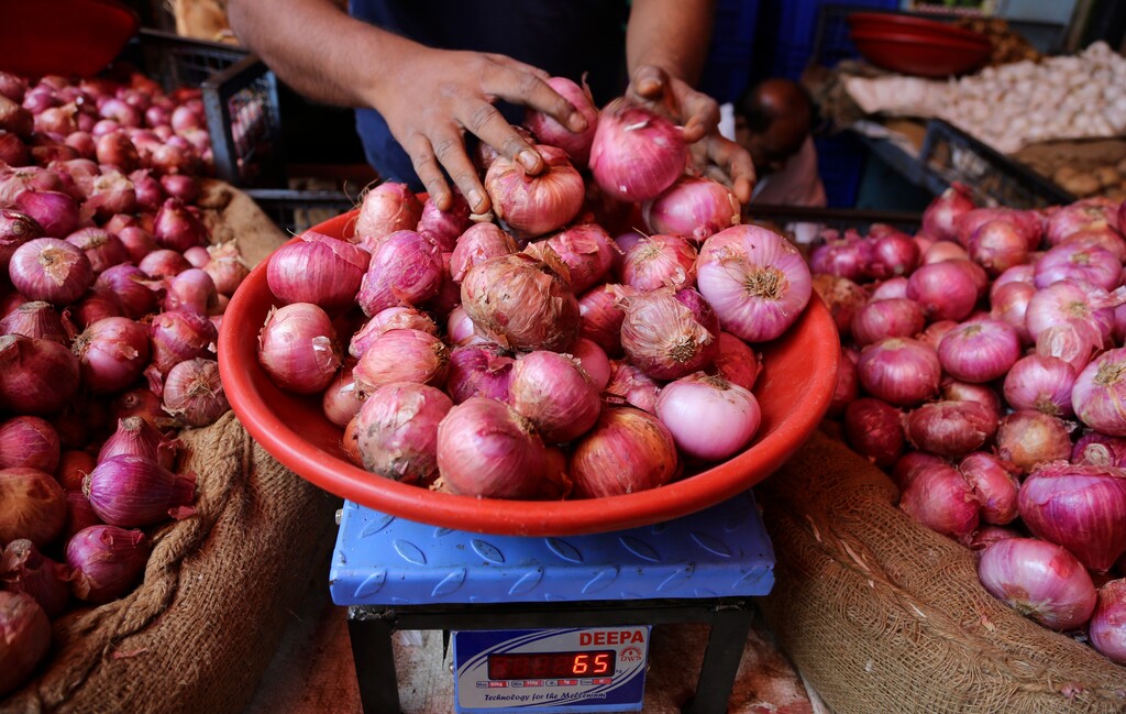 (Aijaz Rahi | AP file photo) In this Tuesday, Dec. 3, 2019, photo, a vendor weighs onions for a customer at a farmers market in Bangalore, India. In the United States, the Food and Drug Administration is warning of a serious outbreak of salmonella that has been traced to California-grown onions. Utah has the second highest number of reported cases.