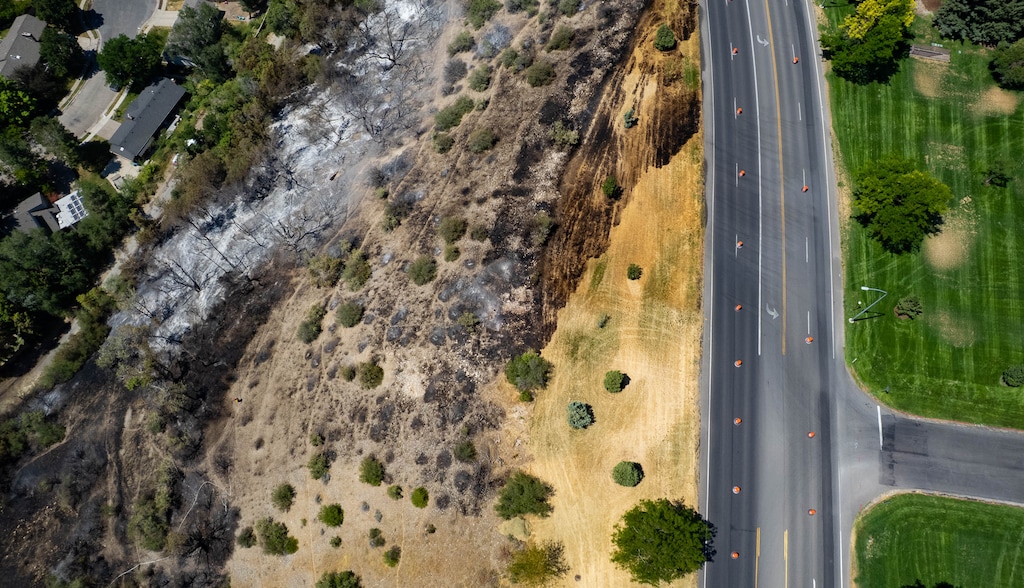 (Francisco Kjolseth | The Salt Lake Tribune) Crews put out hotspots as they attend to the Canyon Road Fire in Logan that burned the night before. Fire officials say it was started by spontaneous combustion.