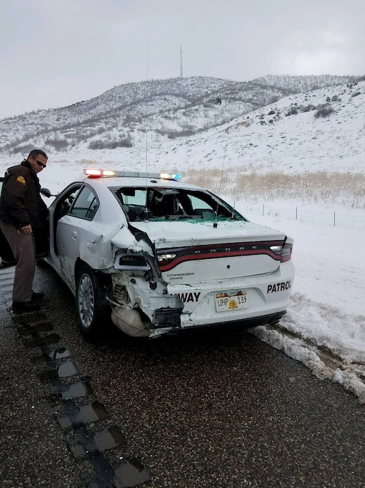 (Courtesy of Utah Highway Patrol)  Highway Patrol Trooper Jeff Rowell pulled off the side of I-15 in Millard County to help a driver hwho had slid off the road on Thursday, Dec.  21, 2017. That's when a mother car lost control and slid into his patrol car.