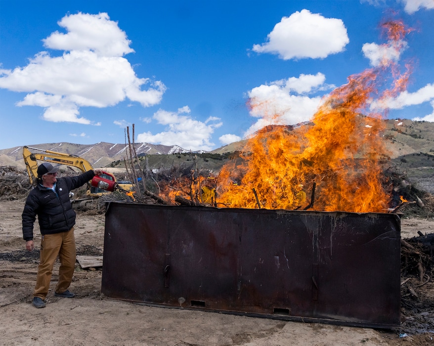 (Rick Egan | The Salt Lake Tribune) John Webster lights up a kiln filled with wood waste, which will produce biochar, at the Tooele County Landfill on Wednesday, April 19, 2023.