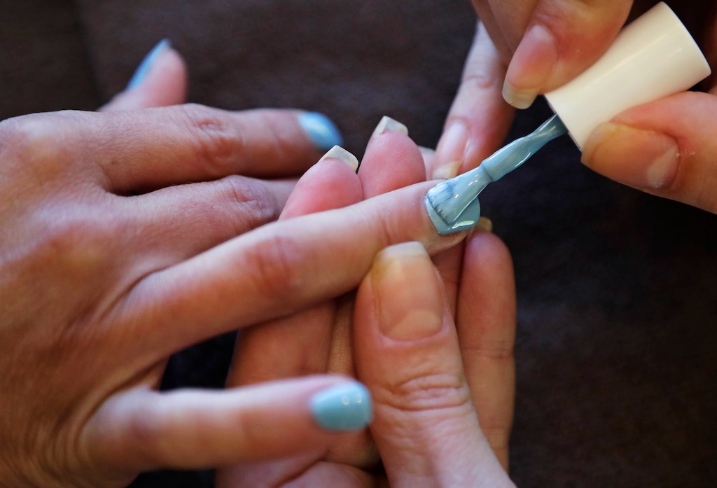 (Charles Krupa | AP photo)
In this Aug. 23, 2016, photo, Christine Perkins, right, who owns Pyara Spa and Salons at two locations in the Boston area, applies nail polish for a client at her salon in Burlington, Mass.