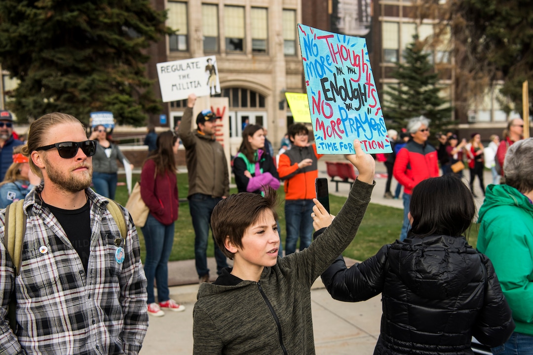 (Chris Detrick  |  The Salt Lake Tribune)  Participants hold signs as the March BeFOR Our Lives' rally walks by during the March for Our Lives' rally West High School in Salt lake City Saturday, March 24, 2018. 