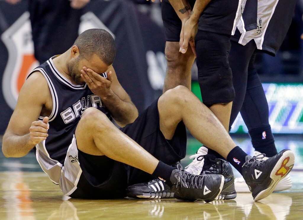 San Antonio Spurs guard Tony Parker holds his face after a collision in the second half of an NBA basketball game against the Utah Jazz, Monday, Feb. 23, 2015, in Salt Lake City. The Jazz won 90-81. (AP Photo/Rick Bowmer)