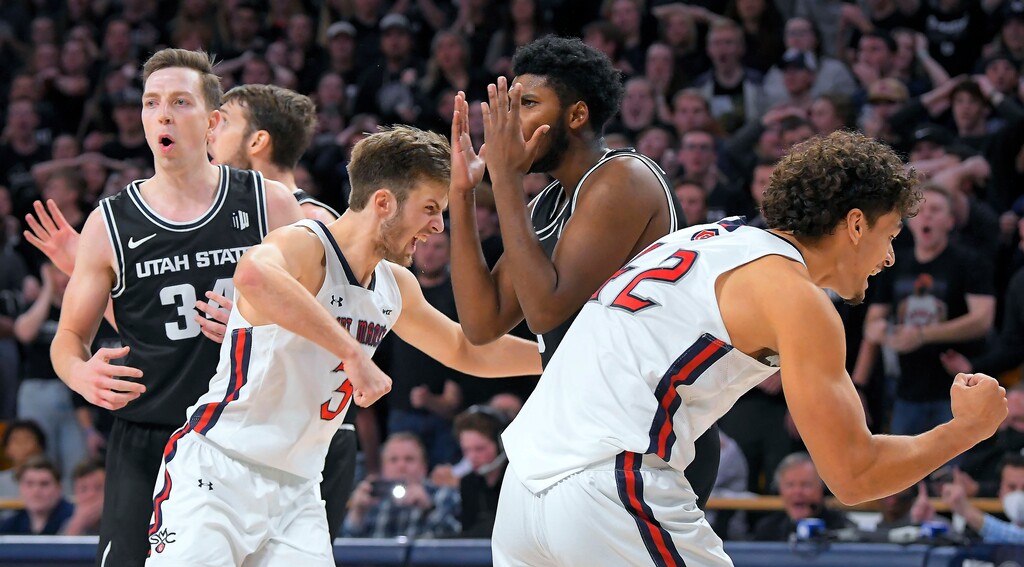 (Eli Lucero | The Herald Journal via AP) Saint Mary's guard Augustas Marciulionis (3) and forward Dan Fotu (42) celebrate after Utah State forward Justin Bean (34) was called for a foul in the final second of an NCAA college basketball game Thursday in Logan.