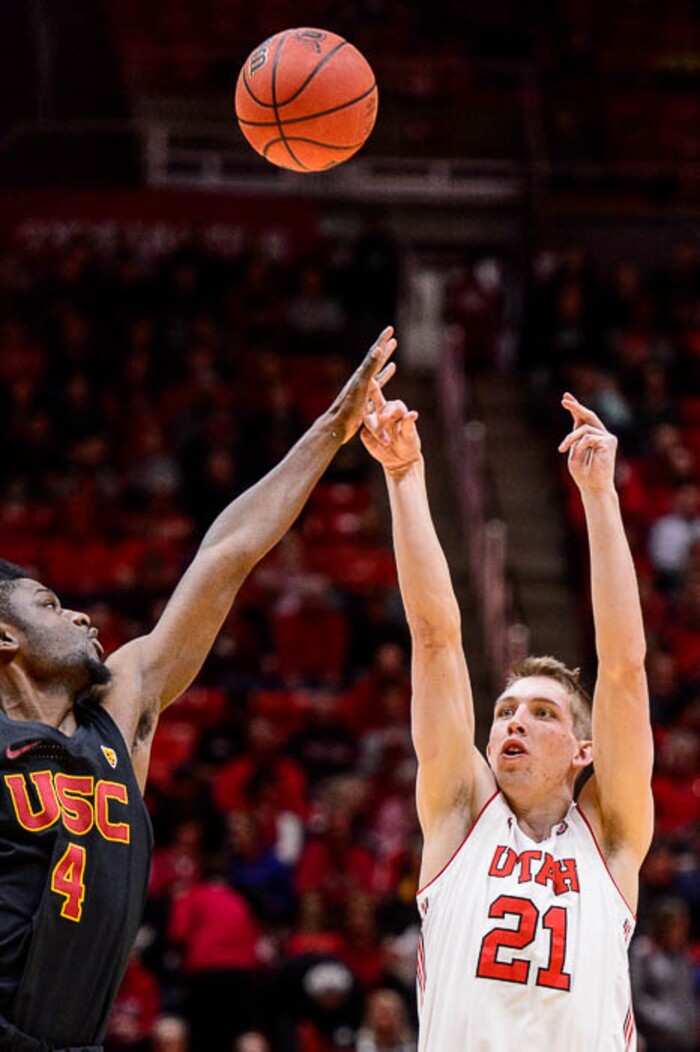(Trent Nelson | The Salt Lake Tribune)  Utah Utes forward Tyler Rawson (21) shoots, with USC Trojans forward Chimezie Metu (4) defending as the University of Utah hosts USC, NCAA basketball at the Huntsman Center in Salt Lake City, Saturday Feb. 24, 2018.
