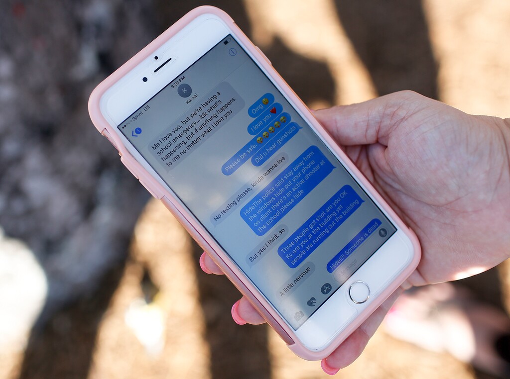 (AP Photo/Brynn Anderson, File) In this Feb. 15, 2018, file photo, Alana Koer, of Parkland, Fla., shows text messages she received from her son the day before, during the shooting at Marjory Stoneman Douglas High School. Koer's son Kai Koer, survived the attack by Nikolas Cruz, a former student who was charged with 17 counts of premeditated murder. Modern technology has enabled real-time reaction, support and calls for action during deadly mass shootings in the U.S. Live video of the Florida shooting showed survivors under desks while others live-tweeted messages to the survivors.