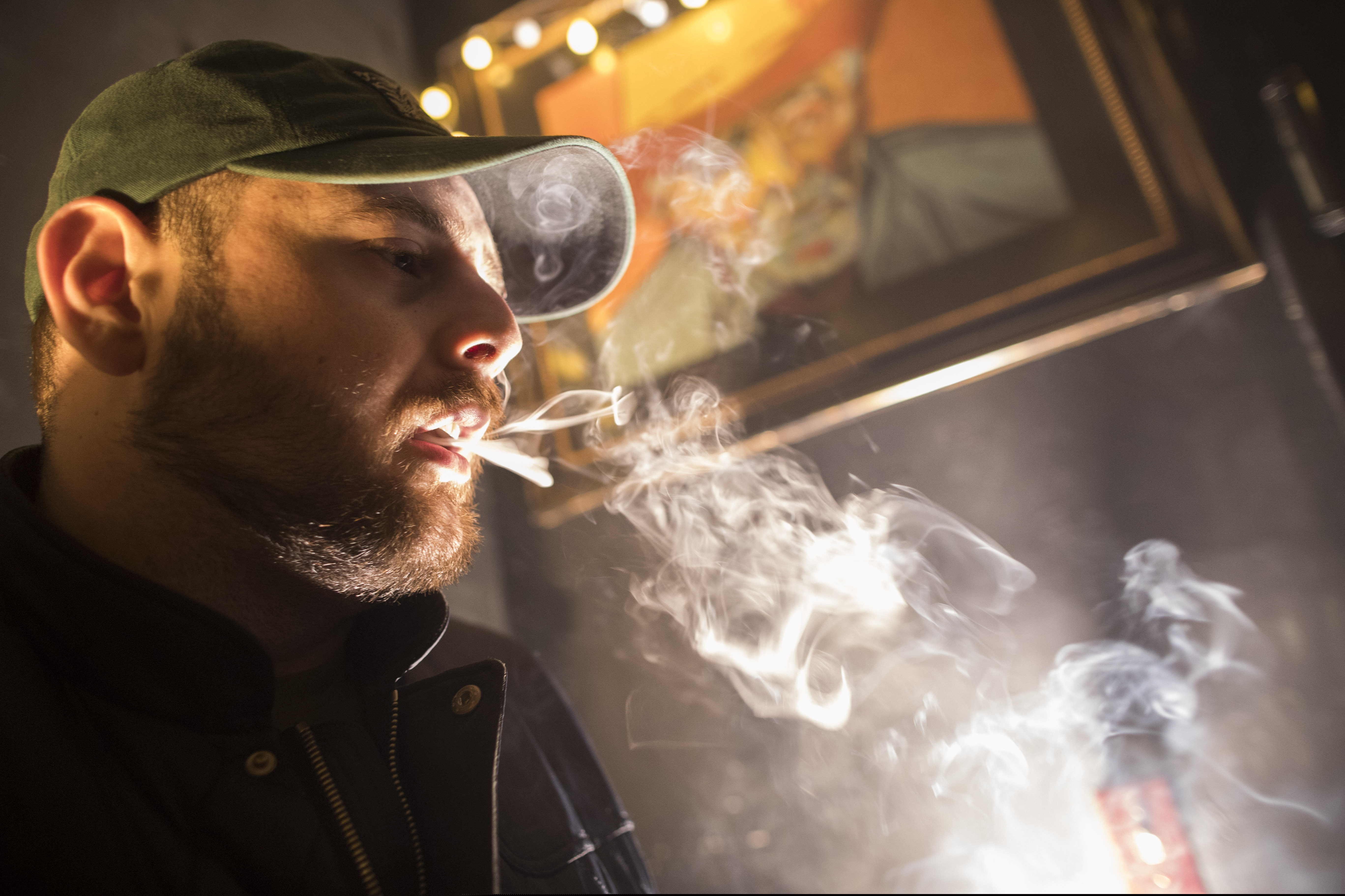 (Mary Altaffer | The Associated Press) In this Friday, March 29, 2019 photo, a man smokes marijuana at a Spleef NYC canna-cocktail party in New York. As more states make it legal to smoke marijuana, some government officials, researchers and others worry what that might mean for one of the country's biggest public health successes: curbing cigarette smoking.