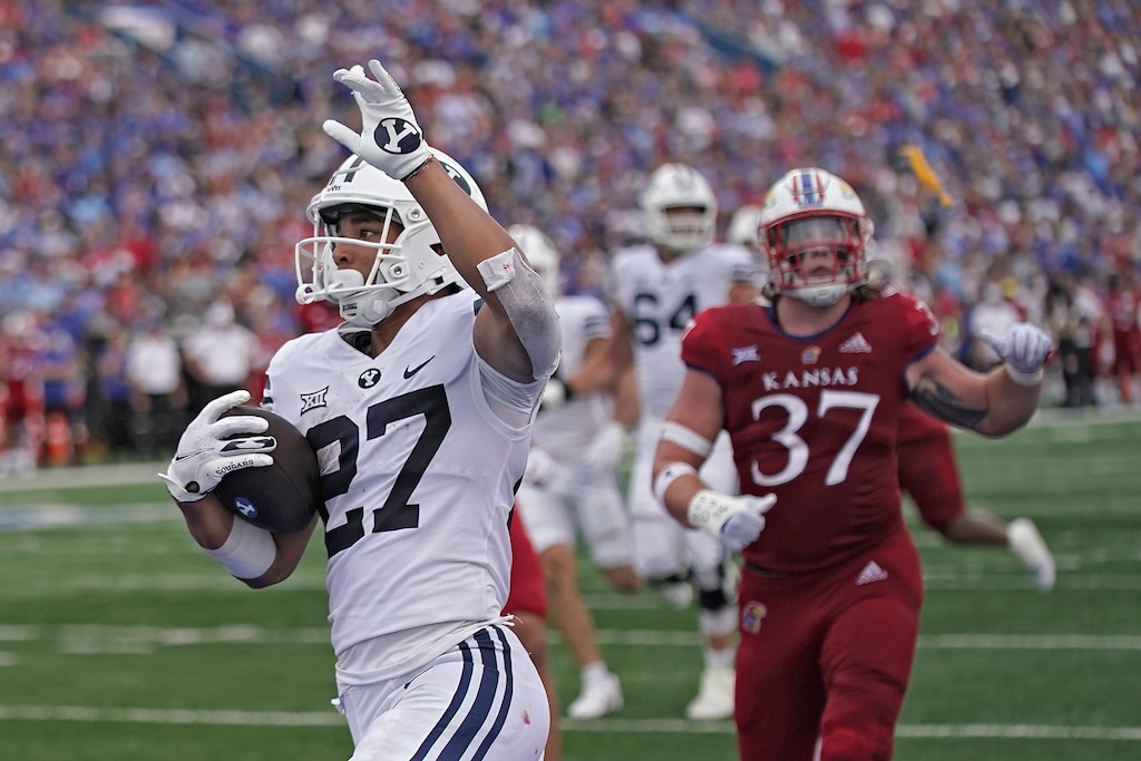 Brigham Young running back LJ Martin (27) celebrates after scoring a touchdown during the first half of an NCAA college football game against Kansas Saturday, Sept. 23, 2023, in Lawrence, Kan. (AP Photo/Charlie Riedel)