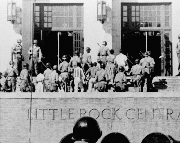FILE - In this Sept. 25, 1957, file photo, nine African American students enter Central High School in Little Rock, Ark., escorted by troops of the 101st Airborne Division. (AP Photo/File)