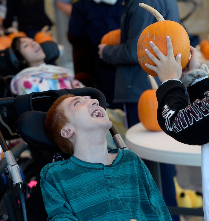 (Al Hartmann | The Salt Lake Tribune)
Bubba Glodowski, a student at Kauri Sue Hamilton School in Riverton eyes a pumpkin grown by inmates in the Green Thumb Nursery program at Utah State Prison. Thousands of pumpkins were harvested this season for donation to local children with significant disabilities.
