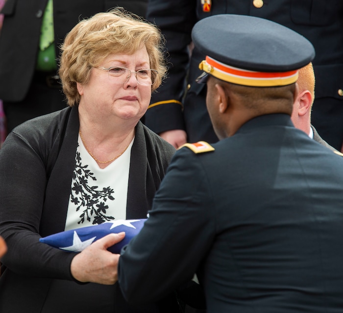 (Rick Egan  |  The Salt Lake Tribune)     A member of the Honor Guard presents Mary Ann Turner, the daughter of 2nd Lt. Lynn W. Hadfield, the flag from her father's casket during the graveside service for 2nd Lt. Lynn W. Hadfield, who was killed during the Second World War, at Veterans Memorial Park, in Bluffdale. Thursday, March 21, 2019.



