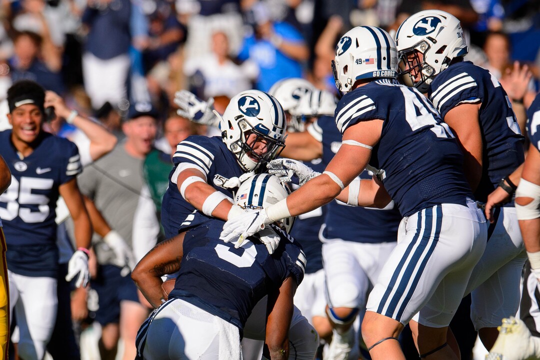 (Trent Nelson  |  The Salt Lake Tribune)  BYU celebrates after Brigham Young Cougars defensive back Dayan Ghanwoloku (5) makes a game-winning interception in overtime as BYU hosts USC, NCAA football in Provo on Saturday Sept. 14, 2019.