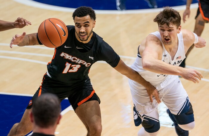 (Rick Egan | The Salt Lake Tribune) Brigham Young Cougars center Richard Harward (42) goes for the ball along with Pacific Tigers forward Jeremiah Bailey (13), in basketball action at the Marriott Center in Provo, on Saturday, Jan. 30, 2021.