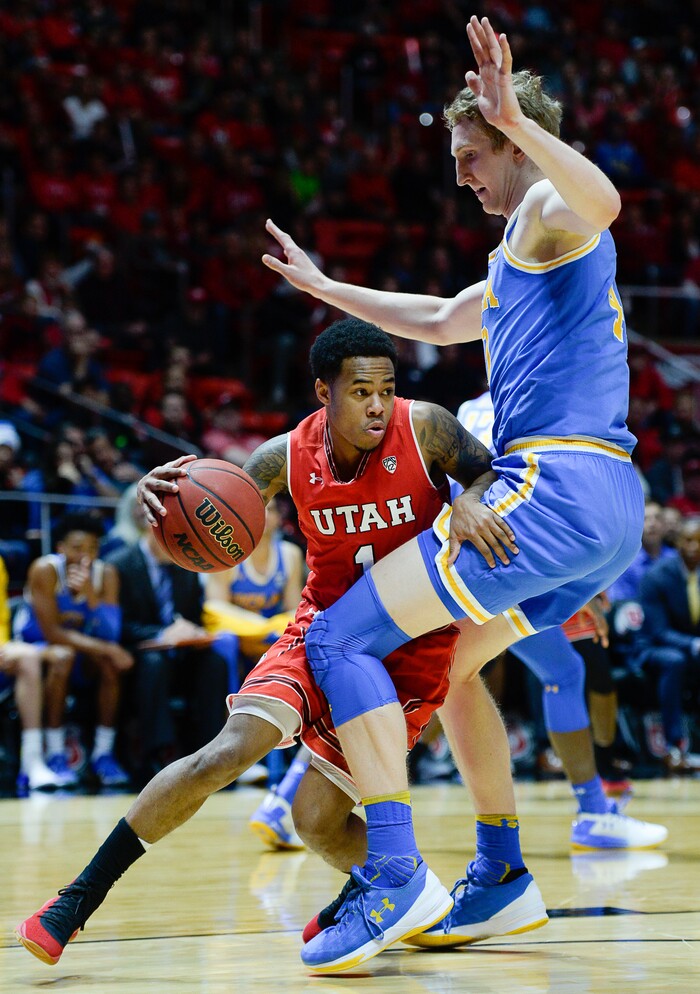 (Francisco Kjolseth  |  The Salt Lake Tribune)  Utah Utes guard Justin Bibbins (1) goes up against UCLA Bruins center Thomas Welsh (40) as the University of Utah hosts UCLA in NCAA basketball at the Huntsman Center in Salt Lake City, Thursday, Feb. 22, 2018.