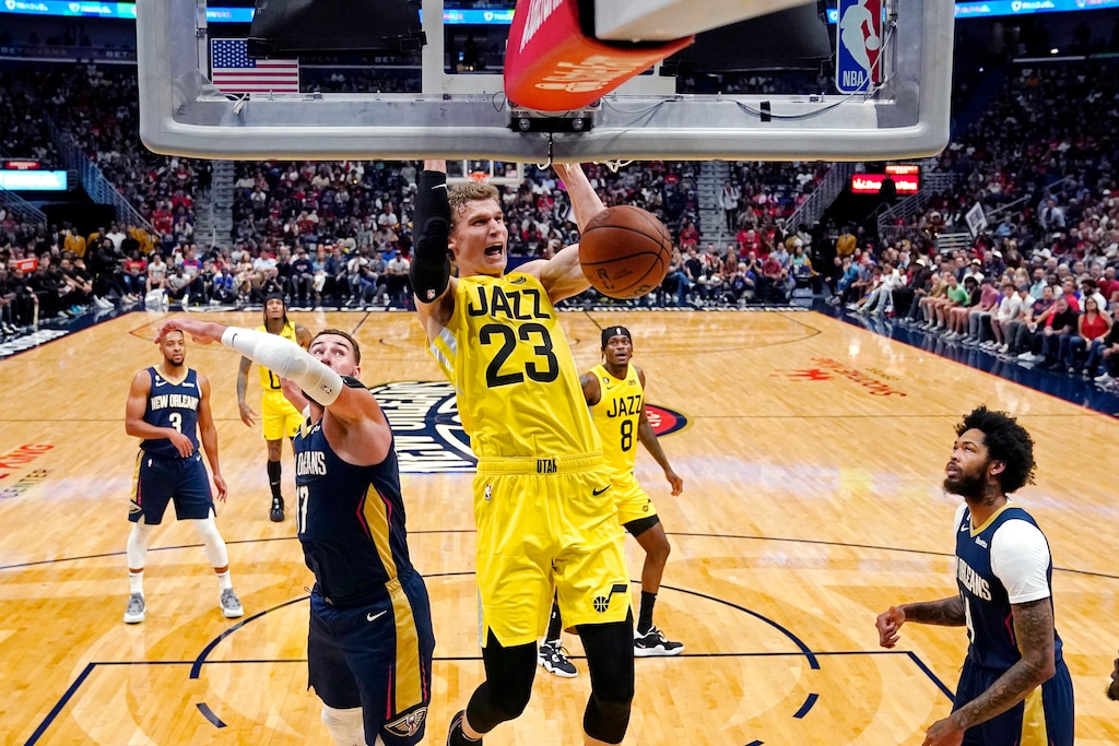 (Gerald Herbert | The Associated Press) Utah Jazz forward Lauri Markkanen (23) slam dunks over New Orleans Pelicans center Jonas Valanciunas, left, and forward Brandon Ingram, right, in the first half of an NBA basketball game in New Orleans, Sunday, Oct. 23, 2022.