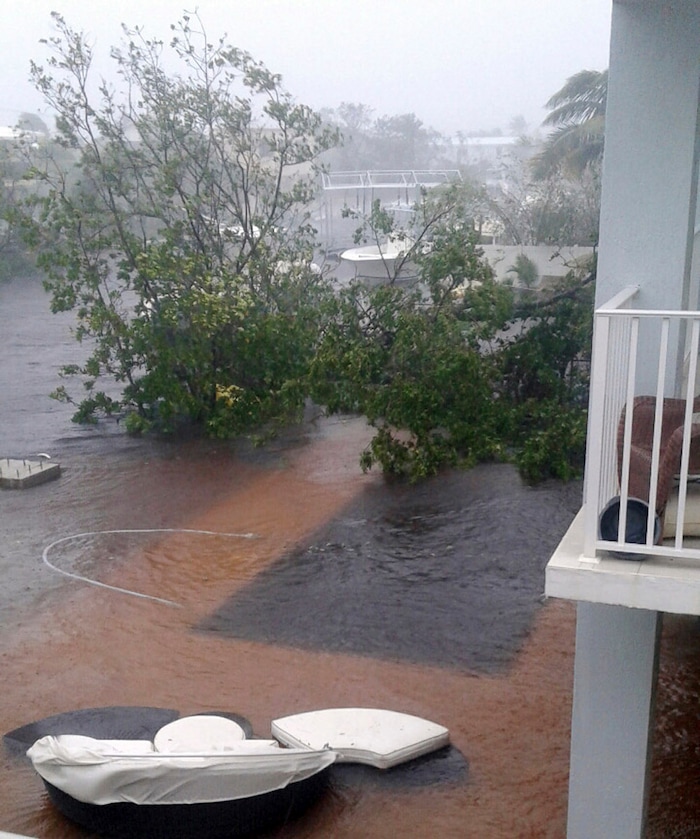 (John Huston via AP) This image made available by John Huston shows the pool underwater at his house as storm surge goes over his dock in Key Largo, Fla., Sunday, Sept. 10, 2017. Announcing itself with roaring 130 mph winds, Hurricane Irma plowed into the mostly emptied-out Florida Keys early Sunday.