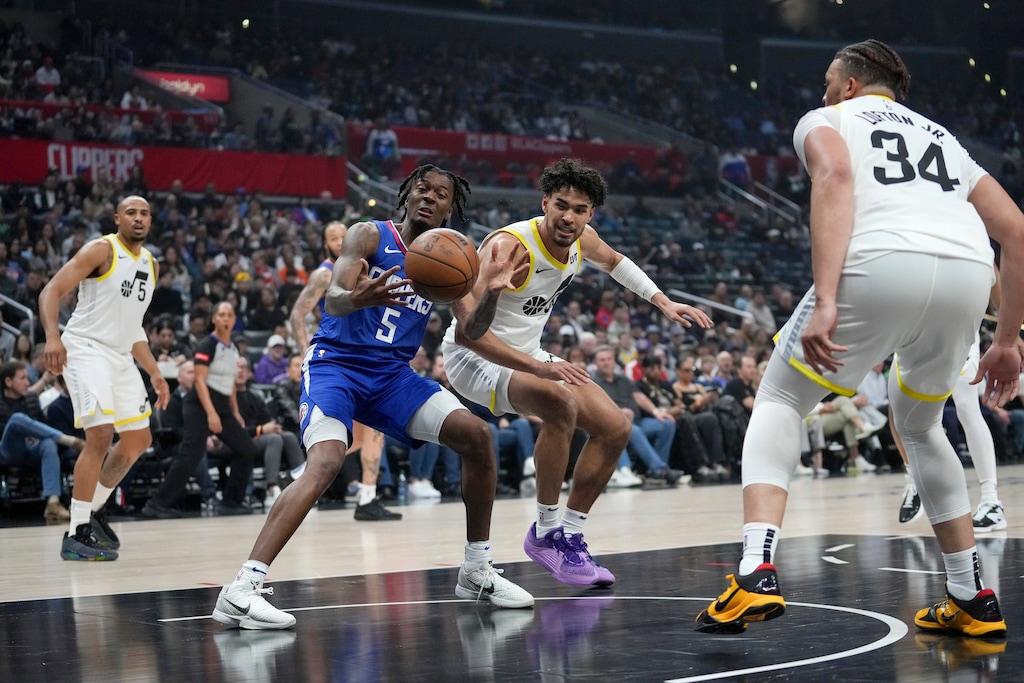 (Eric Thayer | AP) Los Angeles Clippers guard Bones Hyland (5) and Utah Jazz guard Johnny Juzang reach for the ball as Jazz guard Talen Horton-Tucker (5) and forward Kenneth Lofton Jr. (34) watch during the first half of an NBA basketball game in Los Angeles, Friday, April 12, 2024.