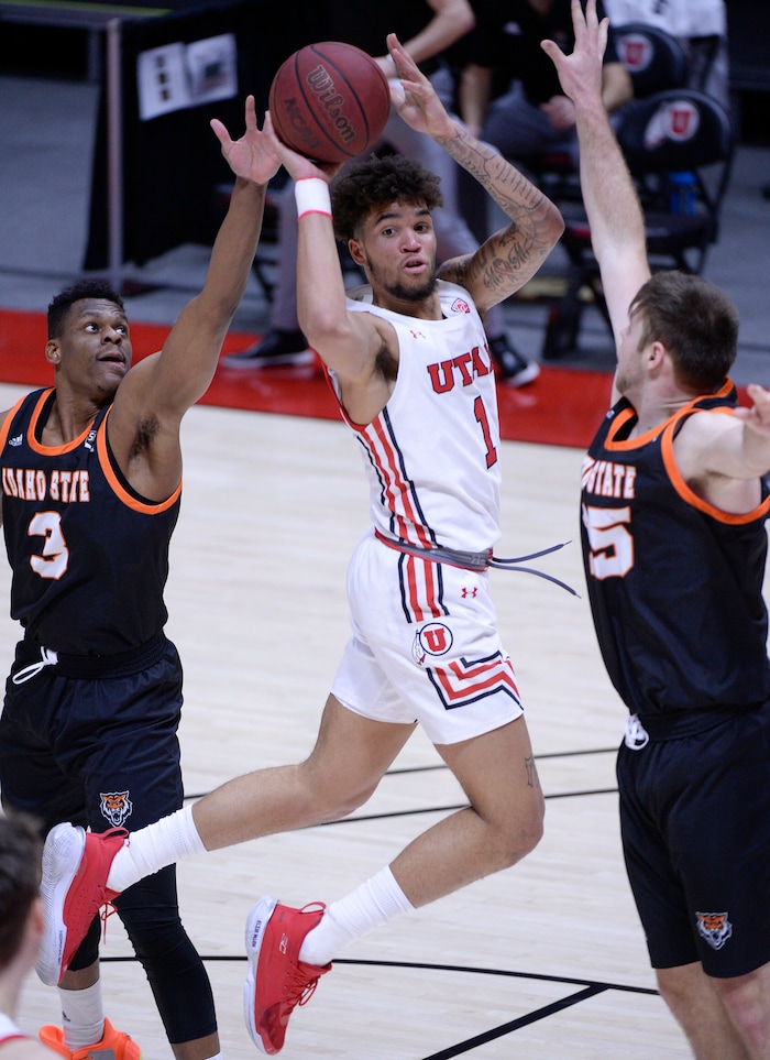 (Leah Hogsten  |  The Salt Lake Tribune) Utah Utes forward Timmy Allen (1) looks for the pass under pressure from Idaho State Bengals forward Malik Porter (3) and Idaho State Bengals center Brayden Parker (25) )during their NCAA basketball matchup Tuesday, Dec. 8, 2020 at the Jon M. Huntsman Center.