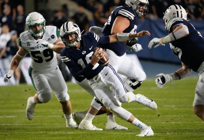 (Francisco Kjolseth | The Salt Lake Tribune) Brigham Young Cougars quarterback Baylor Romney (16) runs in ball in game action between the Brigham Young Cougars and the South Florida Bulls at LaVell Edwards Stadium in Provo, Saturday, Sept. 25, 2021.