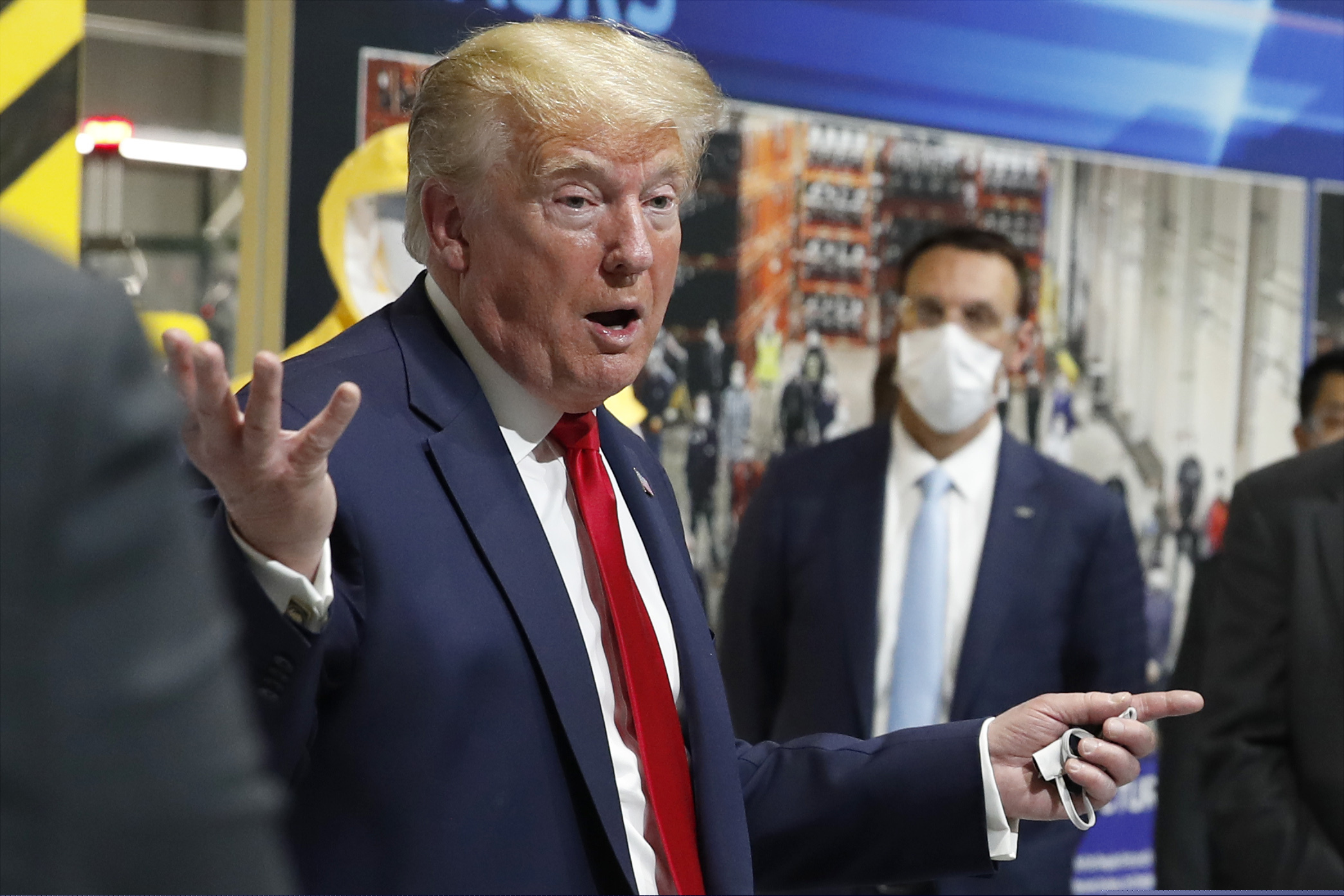 (Alex Brandon | AP file photo)
In this May 21 photo, President Donald Trump holds a face mask in his left hand as he speaks during a tour of Ford's Rawsonville Components Plant that has been converted to making personal protection and medical equipment, in Ypsilanti, Mich. From the U.S. president to the British prime minister's top aide and far beyond, leading officials around the world are refusing to wear masks or breaking confinement rules meant to protect their populations from the coronavirus and slow the pandemic. While some are punished when they're caught, or publicly repent, others shrug off the violations as if the rules don't apply to them.
