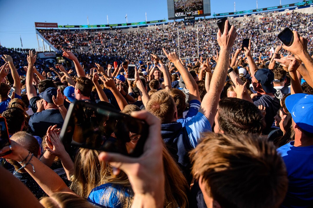 (Trent Nelson  |  The Salt Lake Tribune)  BYU fans rush the field to celebrate the overtime win as BYU hosts USC, NCAA football in Provo on Saturday Sept. 14, 2019.
