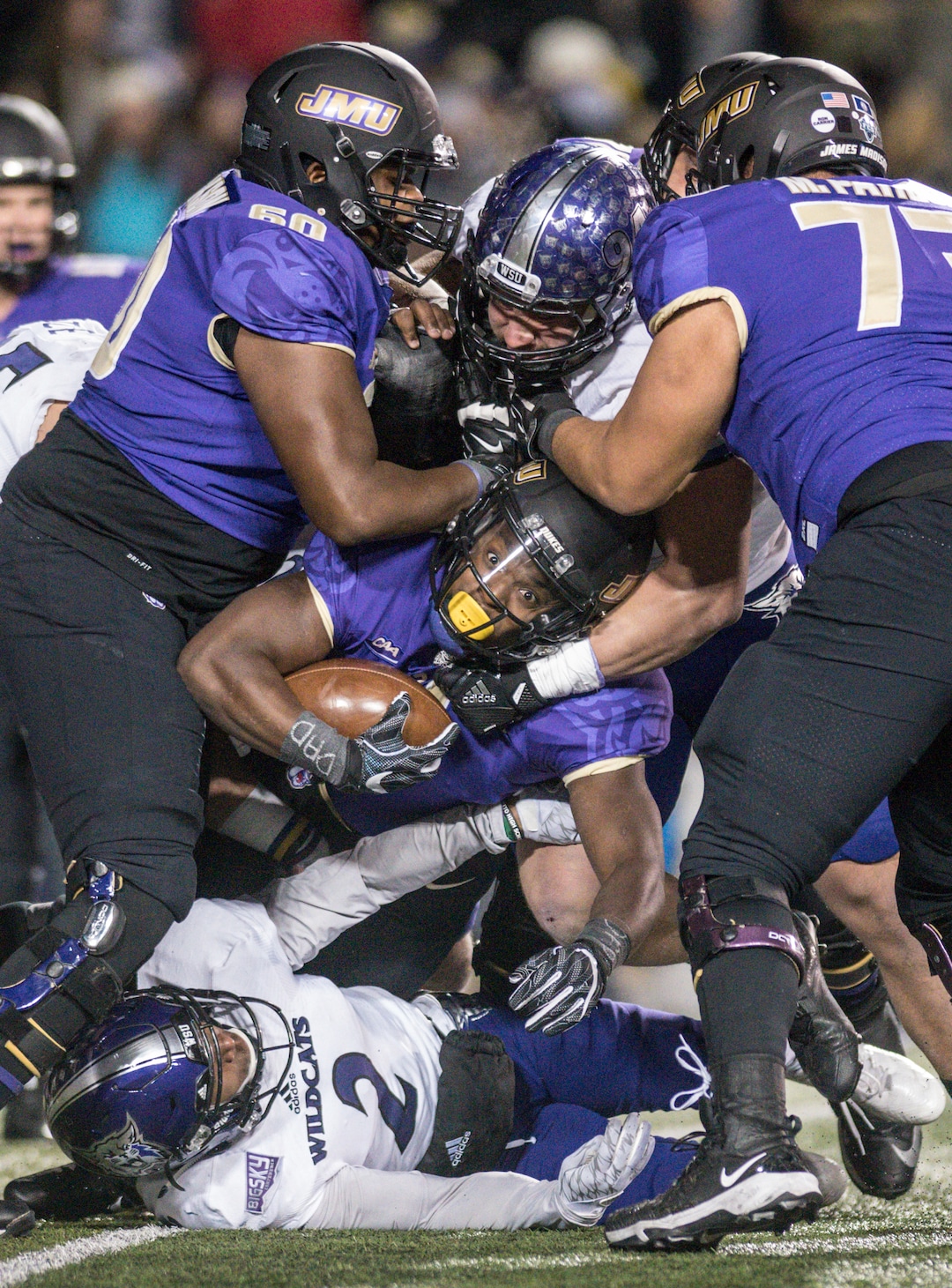James Madison running back Trai Sharp (1) gets stuck in traffic during the first half of an NCAA college football game against Weber State in the quarterfinals of the FCS playoffs Friday, Dec. 8, 2017, in Harrisonburg, Va. (Daniel Lin/Daily News-Record via AP)