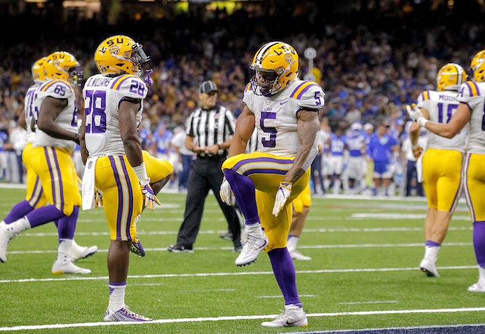 LSU running backs Derrius Guice (5) and Darrel Williams (28) celebrate Guice's first touchdown against BYU in the first half of an NCAA college football game in New Orleans, Saturday, Sept. 2, 2017. (AP Photo/Scott Threlkeld)