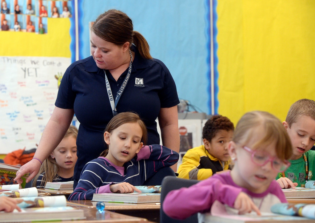 (Al Hartmann | The Salt Lake Tribune)
Second grade teacher Annie Love makes the rounds of her class during a group reading excercise at Midvale Elementary Friday Feb. 9. Last year Midvale Elementary School paid teachers to visit students at their families at home as part of the school's turnaround efforts. But the funding for the program dried up this year. A new bill at the Legislature hopes to create a grant program to support home visits.