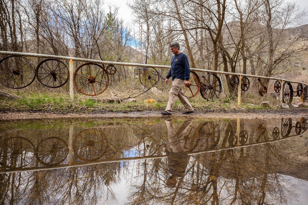 (Trent Nelson  |  The Salt Lake Tribune)  Wayne Hill walks alongside a road covered with water as he prepares for possible flooding at his home on the banks of the South Fork Ogden River east of Huntsville on Monday April 22, 2019.