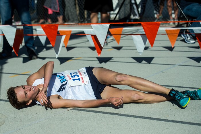 (Chris Detrick  |  The Salt Lake Tribune)  Westlake senior Logan Anderson collapses after crossing the finish line during the 6A boy's state cross-country meet at Sugar House Park and Highland High School Wednesday, October 18, 2017. 