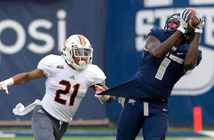 Utah State wide receiver Ron'quavion Tarver (1) catches a pass as Idaho State defensive back Brandon Monroe (21) defends during an NCAA football game Thursday, Sept. 7, 2017, in Logan, Utah. (Eli Lucero/Herald Journal via AP)