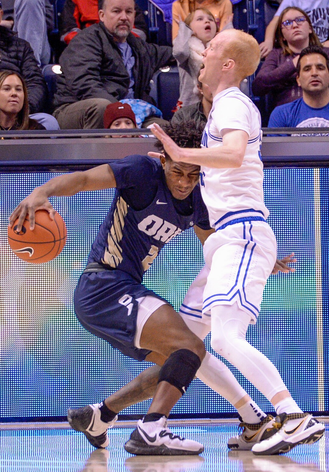 (Leah Hogsten  |  The Salt Lake Tribune) Oral Roberts Golden Eagles guard Deondre Burns (2) is charged with an offensive foul as he runs into Brigham Young Cougars guard TJ Haws (30) as Brigham Young University hosts Oral Roberts, Dec. 28, 2019 at the Marriott Center in Provo.