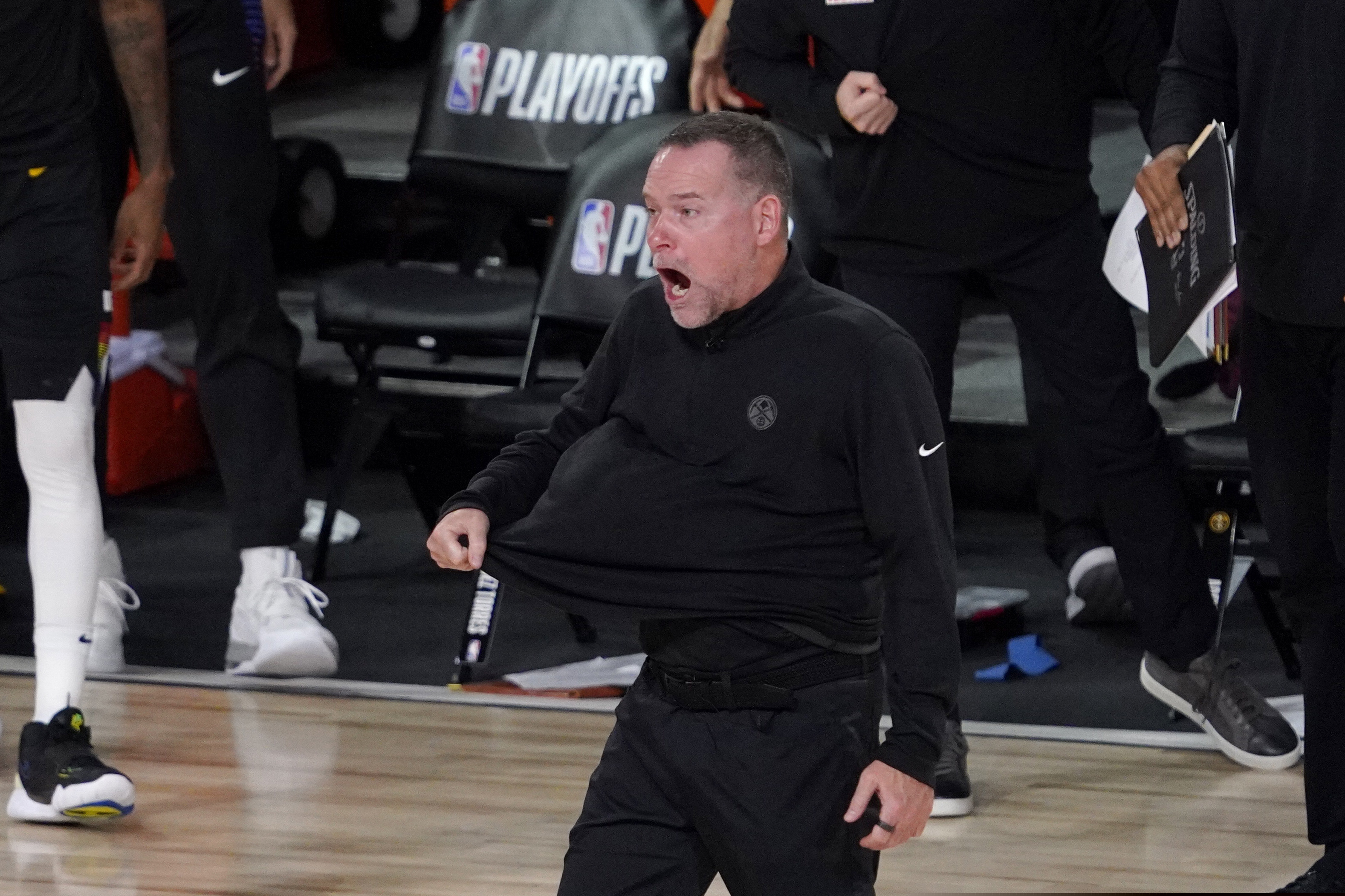 Denver Nuggets head coach Michael Malone walks onto the court during a time out in the second half an NBA first round playoff basketball game against the Utah Jazz on Tuesday, Sept. 1,2020, in Lake Buena Vista, Fla. (AP Photo/Mark J. Terrill)
