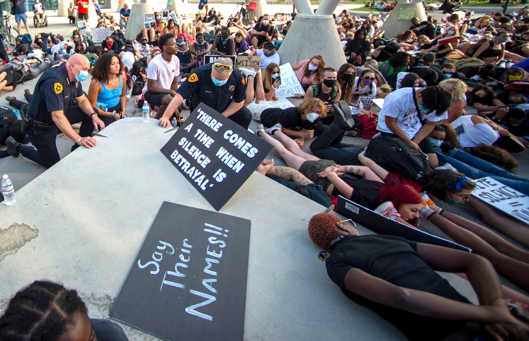 ((Rick Egan  |  The Salt Lake Tribune) Salt Lake City Police Chief Mike Brown kneels in silence for 9 minutes in memory of George Floyd with a group of demonstrators at the Public Safety Building, Wednesday, June 3, 2020.