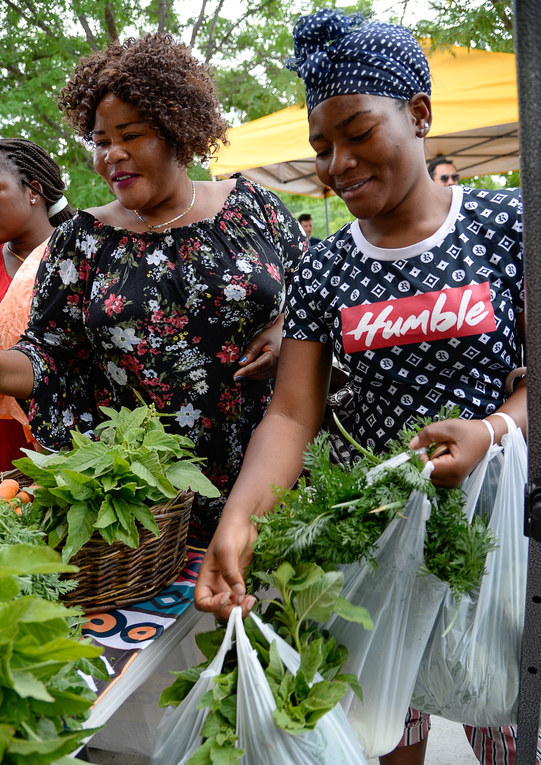 (Francisco Kjolseth  |  The Salt Lake Tribune)   Francine Nitgenga of Congo, left, and her daughter Nima Abakuki load up on fresh vegetables for their large family at the Sunnyvale Farmers Market at 4013 S. 700 West, which draws a weekly refugee clientele on Saturday, July 13, 2019, selling food grown exclusively by refugees living in Utah.
