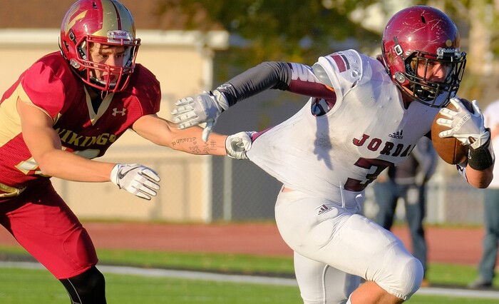 (Leah Hogsten  |  The Salt Lake Tribune) Viewmont's Cole Salmon tries to stop Jordan's Jacob Shaver. Jordan High School boys' football team defeated Viewmont High School 28-20 during their class 5A football playoff opener, Friday, October 27, 2017 in Bountiful.