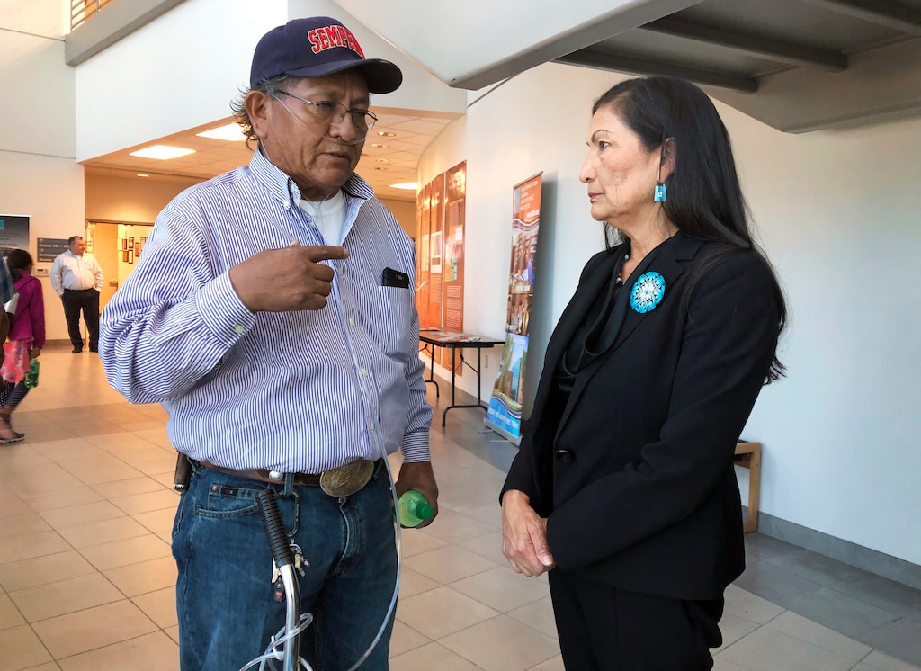 (Mary Hudetz | AP) Leslie Begay, left, speaks with U.S. Rep. Deb Haaland, D-New Mexico, in a hallway outside a congressional field hearing in Albuquerque, N.M., highlighting the atomic age's impact on Native American communities on Monday, Oct. 7, 2019. Begay, a former uranium miner on the Navajo Nation with lung problems, says there are lingering injustices and health problems on his reservation decades after mines closed. An Indian Health Service official cited federal research at the hearing that she says showed some Navajo women, males and babies who were part of the study had high levels of uranium in their systems.