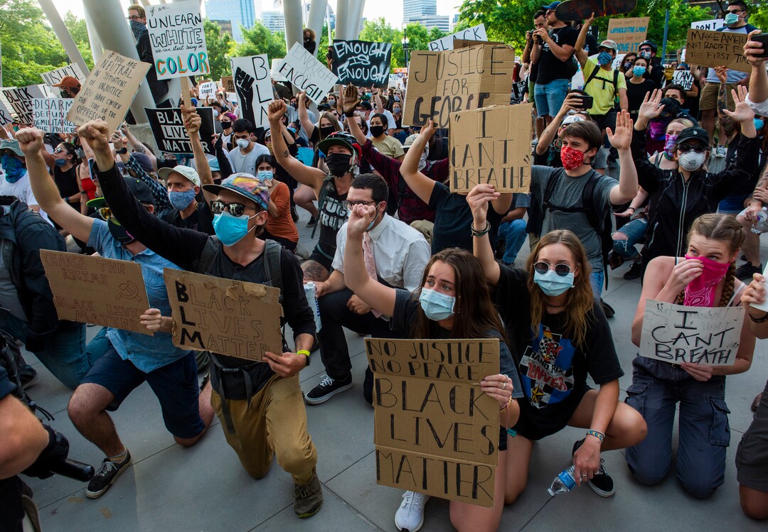 (Rick Egan  |  The Salt Lake Tribune)     Protesters urge the police to kneel with them at the Public Safety Building in Salt Lake City, Monday, June 1, 2020.