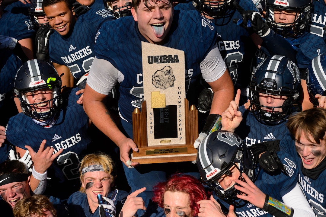 (Trent Nelson  |  The Salt Lake Tribune) Corner Canyon's Jackson Light holds the trophy while celebrating with teammates after the 6A state football championship game against Lone Peak at Cedar Valley High School in Eagle Mountain on Friday, Nov. 20, 2020.