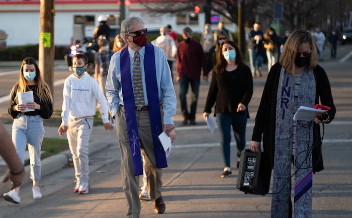 (Francisco Kjolseth | The Salt Lake Tribune) Rev Steve Aeschbacher and Rev Christine Myers-Tegeder join other mask wearing Utah Christians as they walk the streets of Salt Lake City beginning at Cathedral of the Madeleine on Good Friday, to symbolically mark Jesus' carrying the cross to his crucifixion, April 2, 2021.