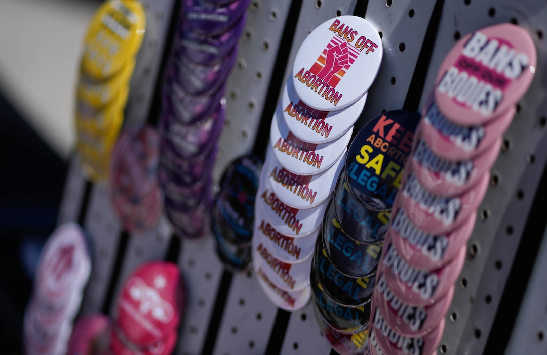 (Francisco Kjolseth | The Salt Lake Tribune) Abortion rights buttons are sold as protesters gather at the Utah Capitol for a “Bans Off Our Beehive” rally in support of abortion rights on Saturday, May 14, 2022.