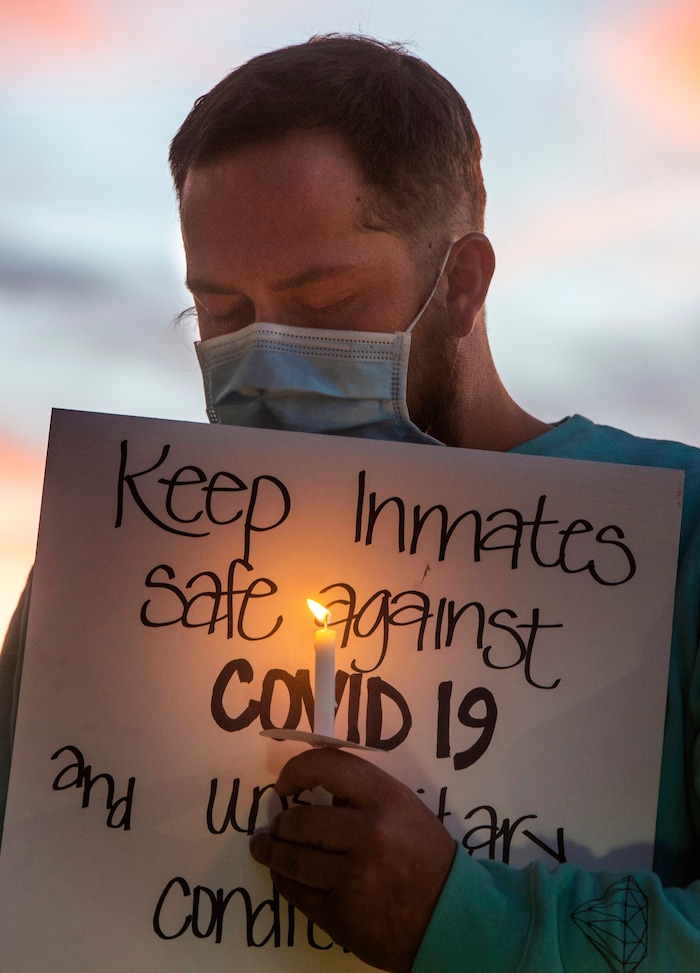 (Rick Egan  |  The Salt Lake Tribune)   A man named Tanner holds a candle during a prayer for inmates, after a COVID-19 outbreak has spread at the Draper prison, during a rally at the Department of Corrections, on Tuesday, Oct. 13, 2020.