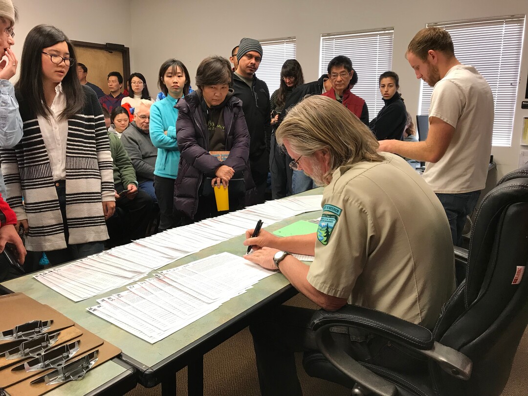(Jennifer Kumar | Courtesy) Hopeful hikers crowd into the U.S. Bureau of Land Management's Kanab visitors center Dec. 28, 2017 to apply for a permit drawing to visit North Coyote Buttes, which includes The Wave rock formation, at the Utah-Arizona state line. The Wave is an iconic attraction in the Paria Canyon-Vermilion Cliffs Wilderness Area. Only 20 people per day may visit North Coyote Buttes; 10 permits are granted at the daily drawing in Kanab, and 10 are distributed in an online lottery.